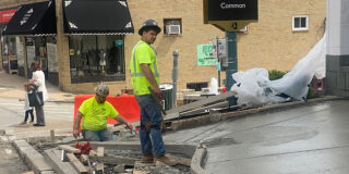 Men wearing bright shirts working at a construction site