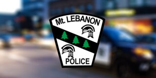 The Mt. Lebanon Police Department logo on top of a blurred image of a police car.