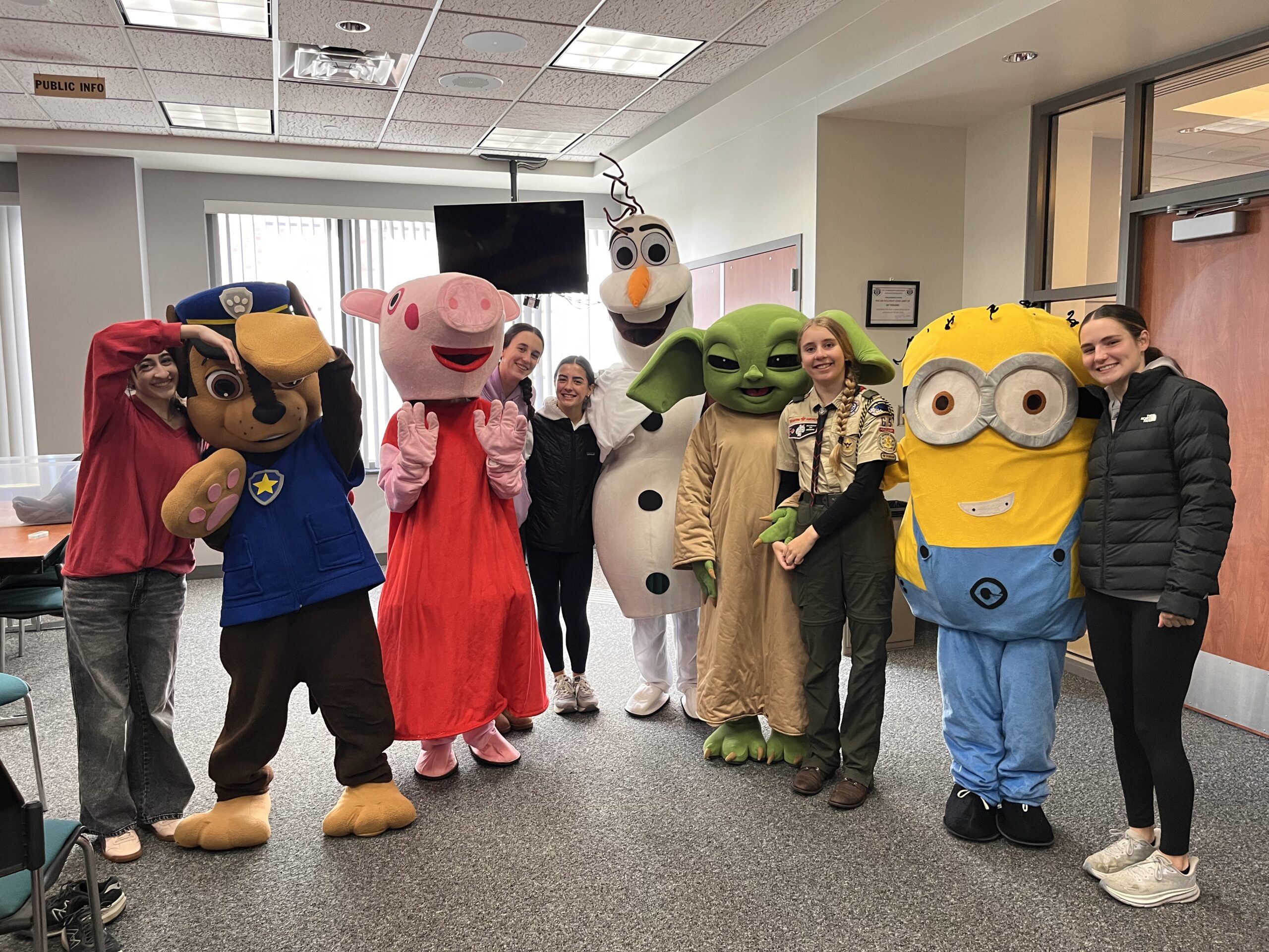 Volunteers alongside mascots