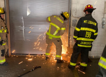 Mt. Lebanon Fire Department firefighters work to open garage door during training