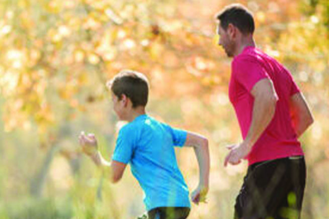 Father and son jogging in park