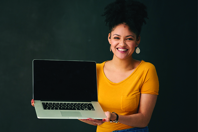Woman holding a macbook computer