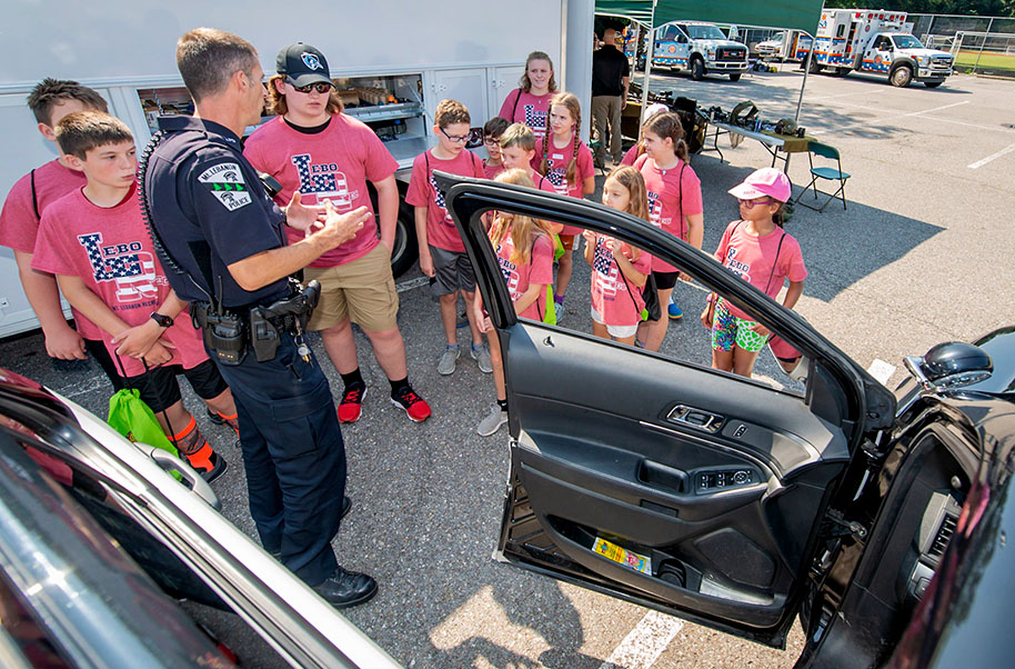 Police officer with kids at Public Safety camp