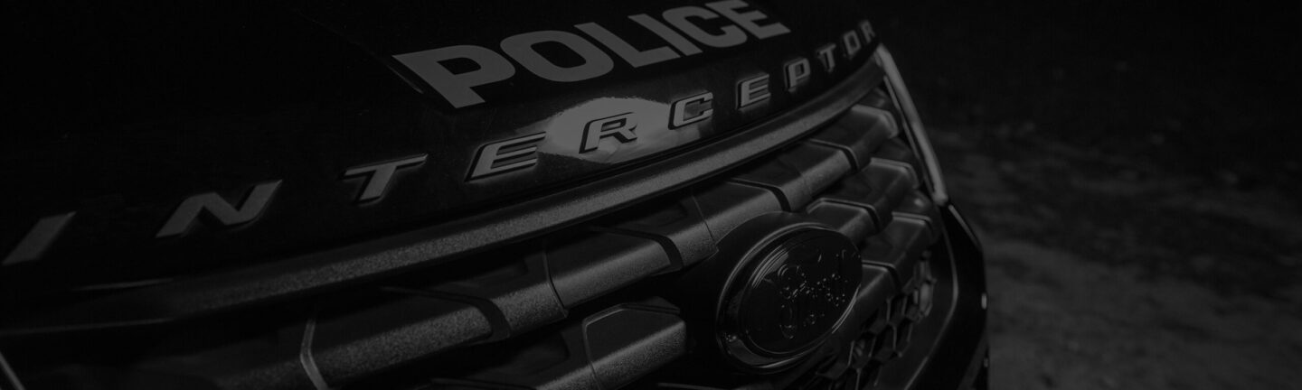Black and white image of the front of a police cruiser