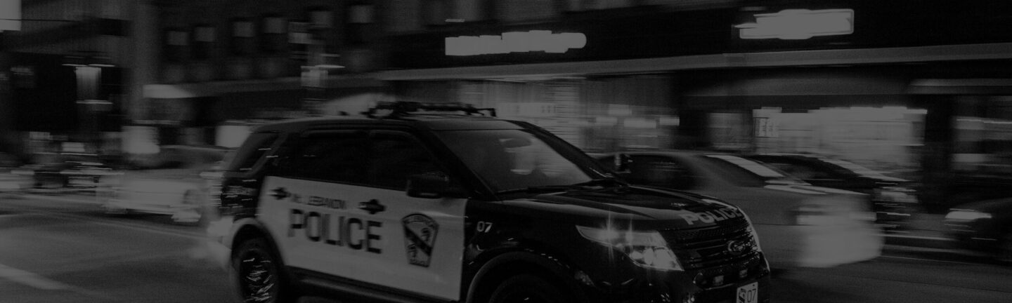 black and white image of a police car