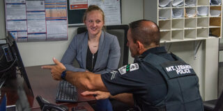 A woman chats with a police officer