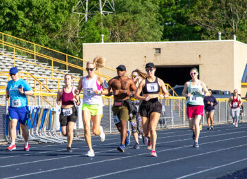 People running on a rack with race bibs